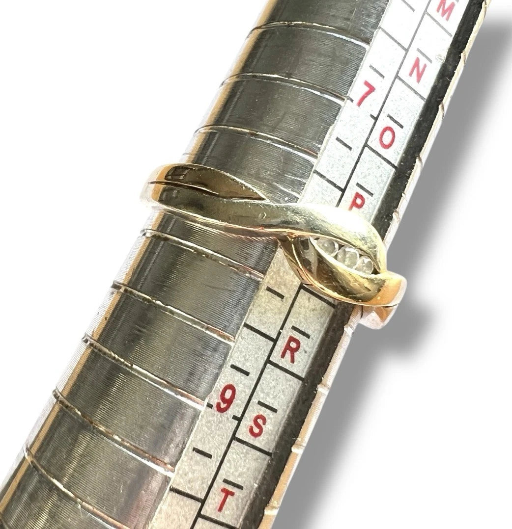 Close-up of a ring sizer with a gold ring and measurement scale.