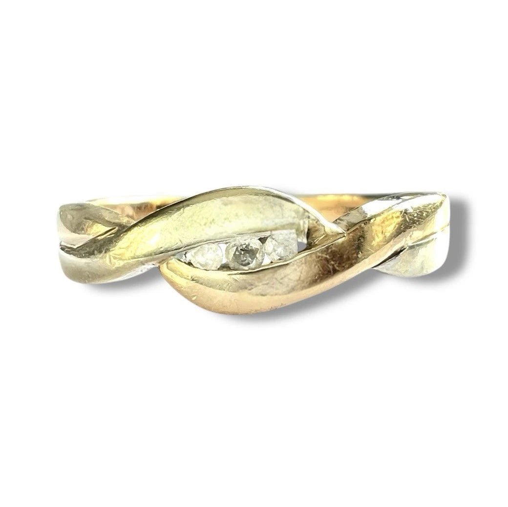 Close up front view of gold ring with a diamond on a white background