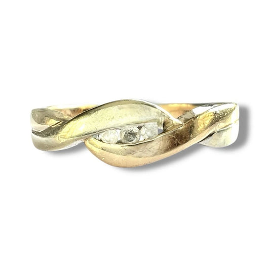 Close up front view of gold ring with a diamond on a white background