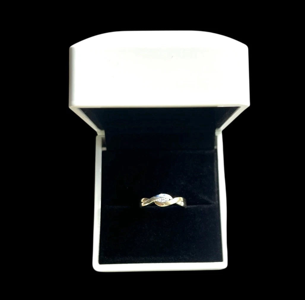 Gold ring in a white box with a black interior