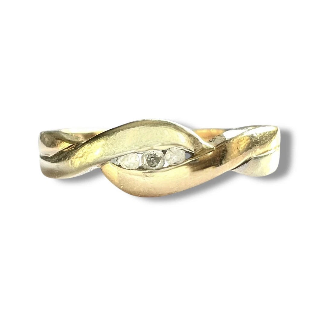 Gold ring with three diamonds on a white background