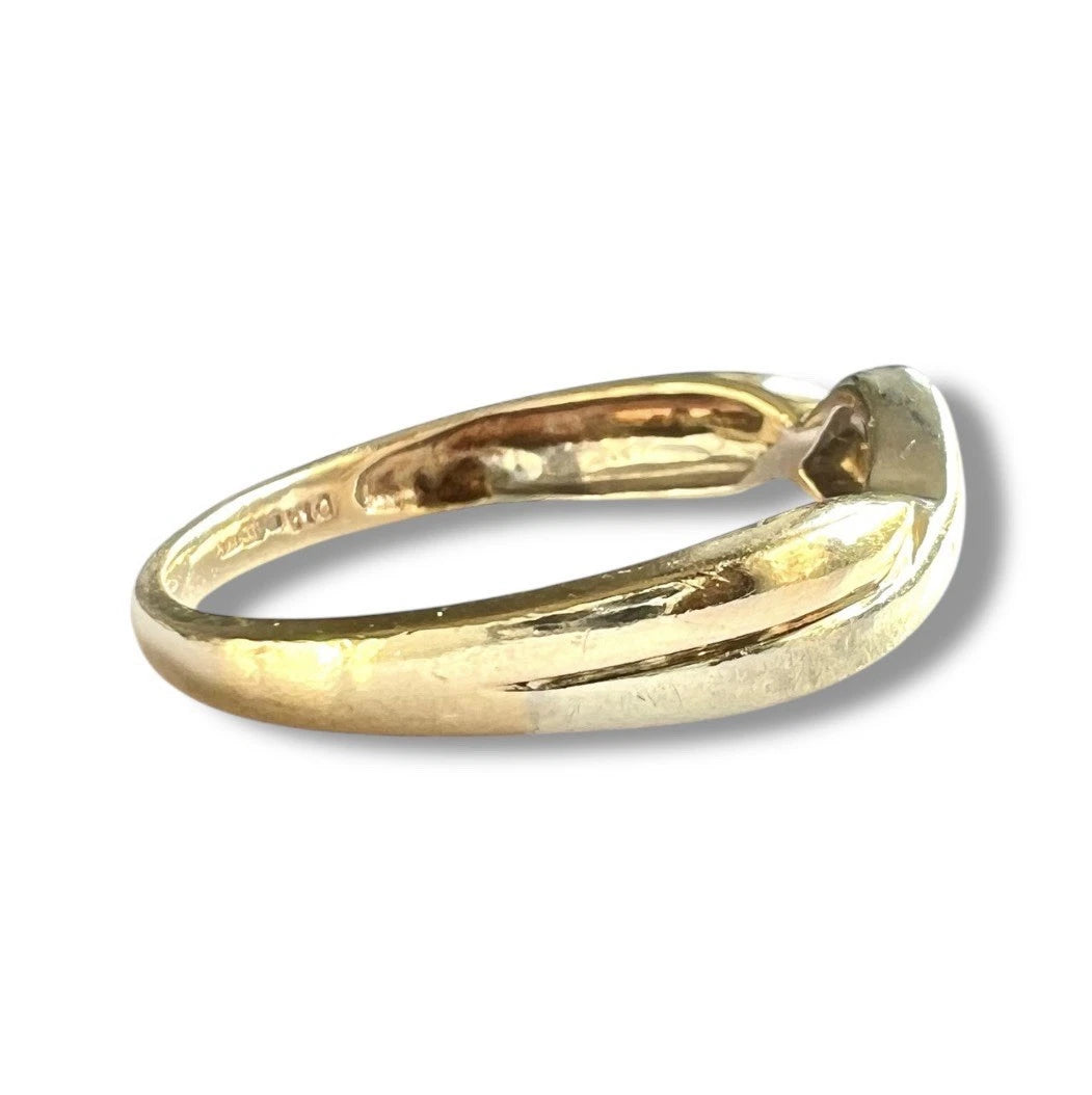 Gold ring on a white background. Close up side view 