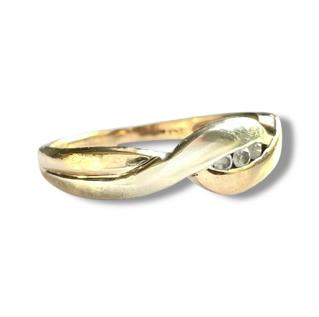 Gold ring with a diamond on a white background