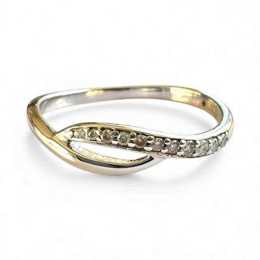 Close-up front view of White Gold ring with embedded diamonds on a white background