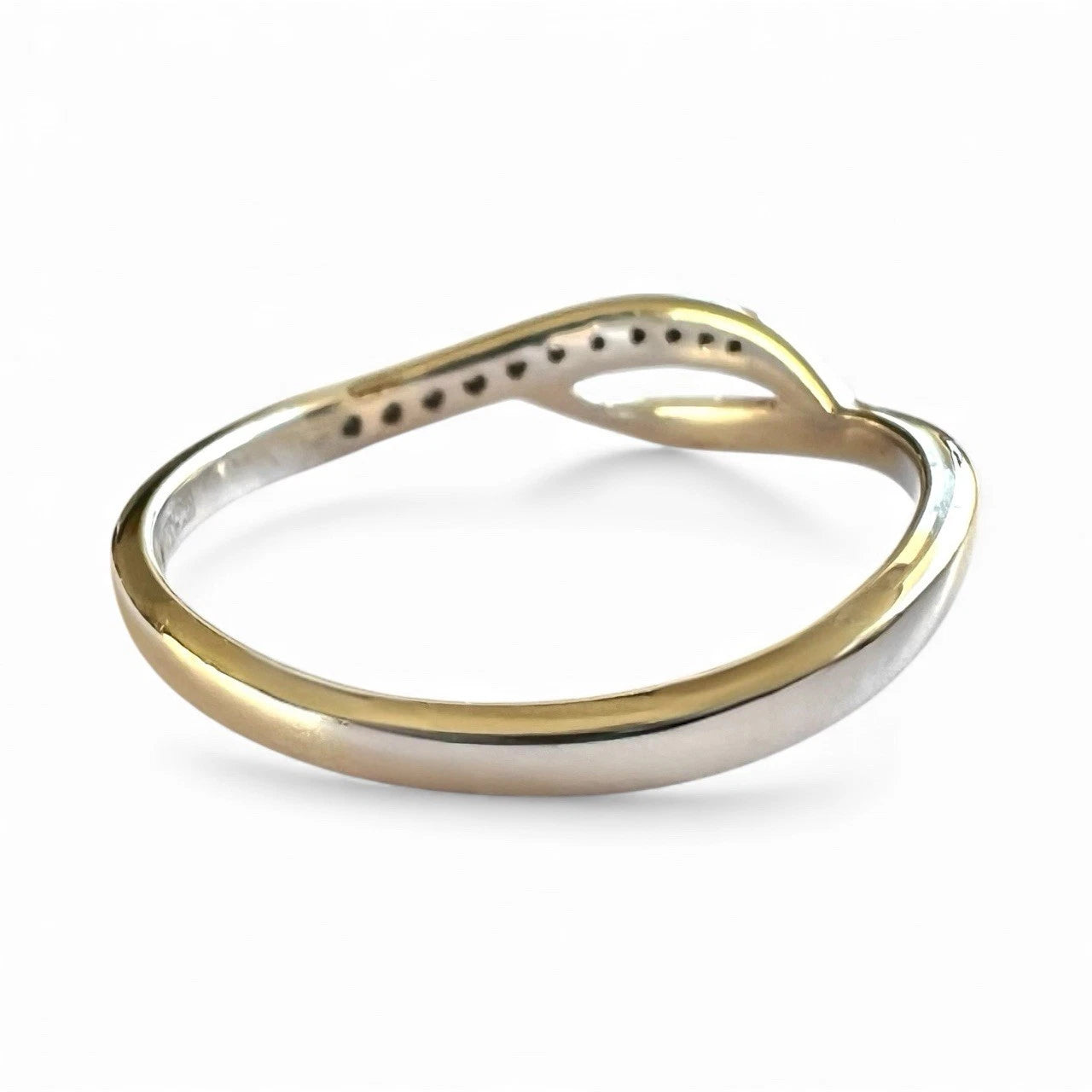 Close-up rear view of White Gold diamond ring on a white background 