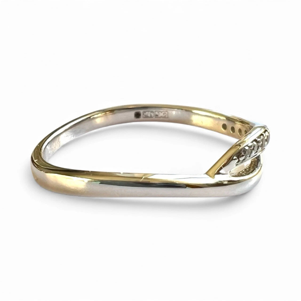 White Gold ring with a diamond on a white background close-up side view 