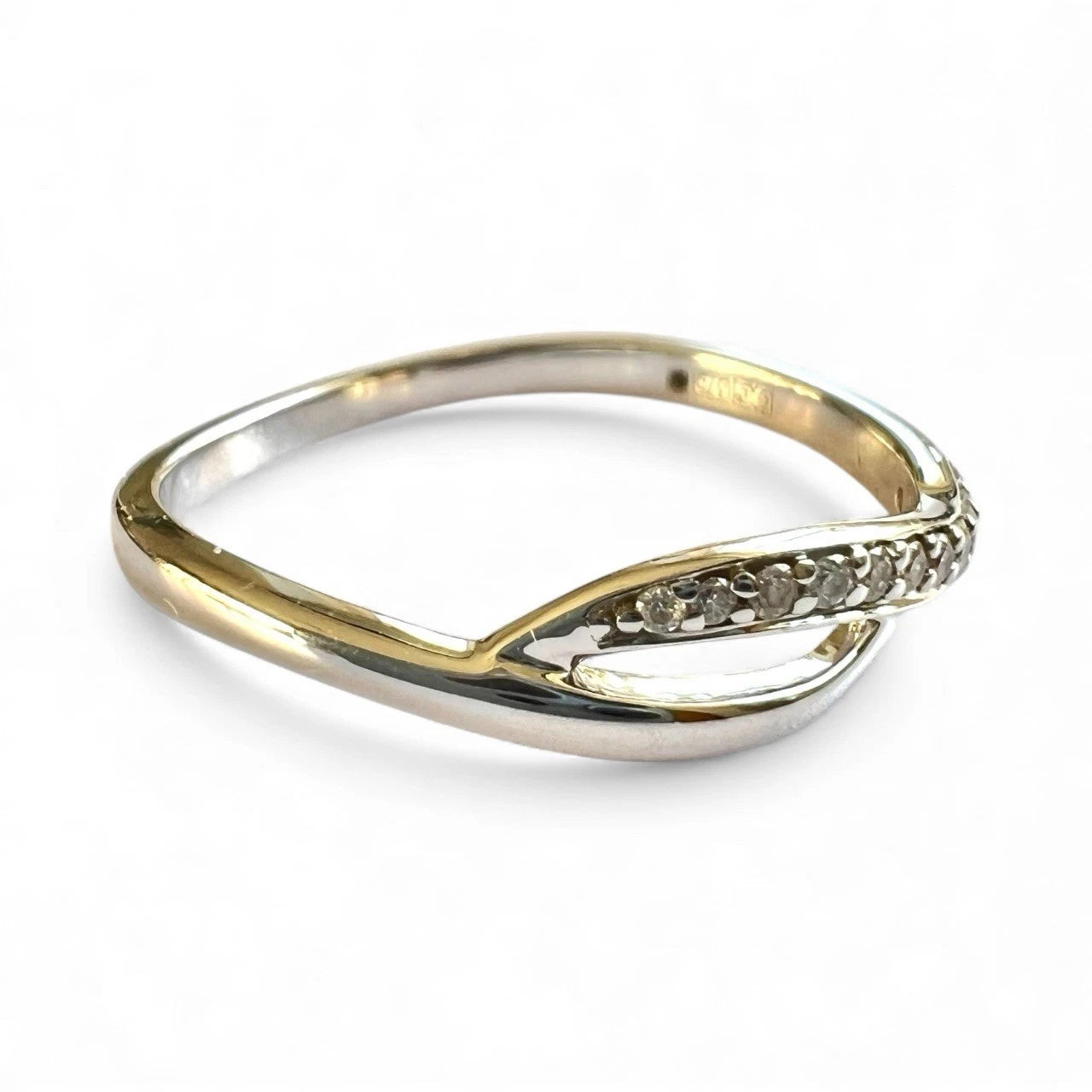 Gold ring with small diamonds on a white background