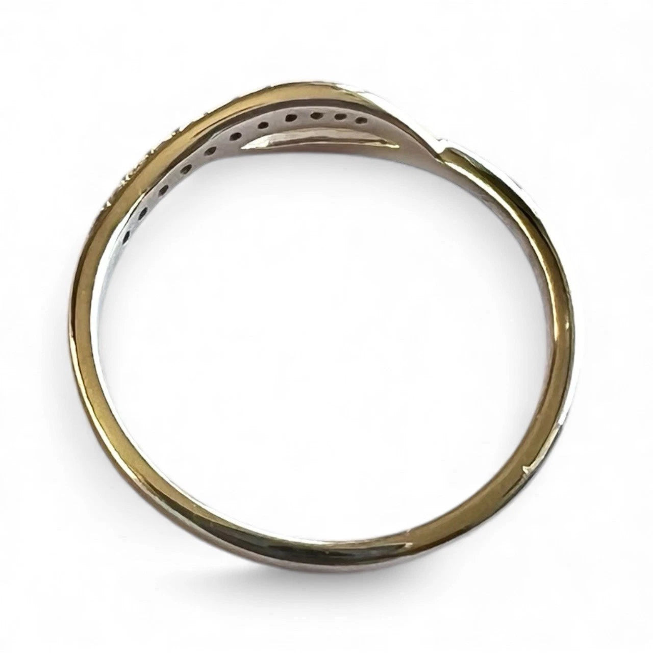 Gold ring with a diamonds on a white background close-up top down view 