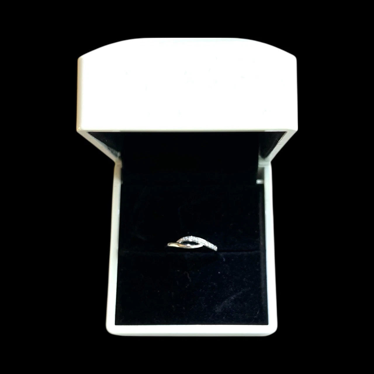 Diamond ring in a white box on a black background