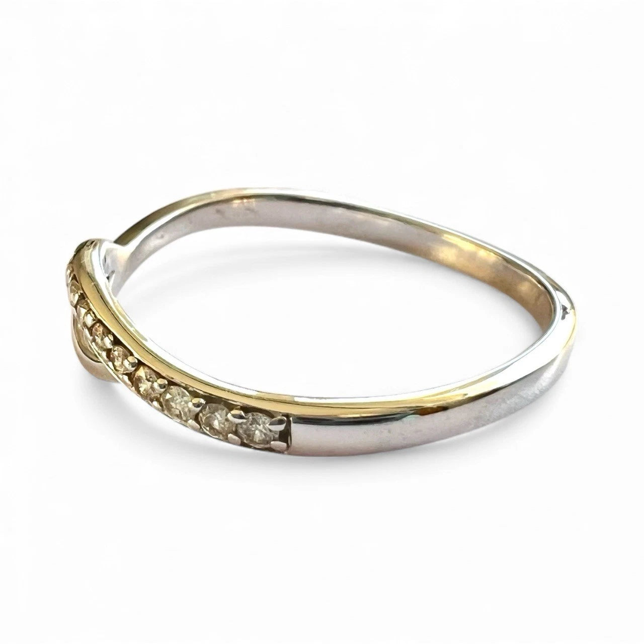 White gold ring with small diamonds on a white background close up 
