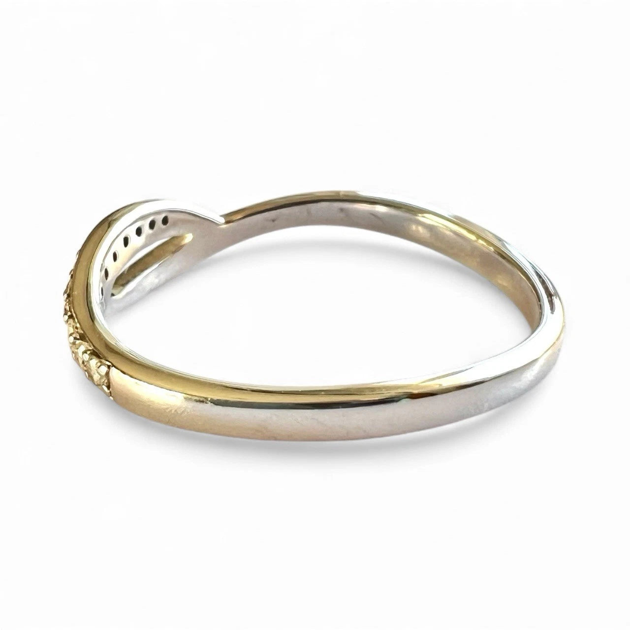 Close-up side view of white Gold diamond ring on a white background