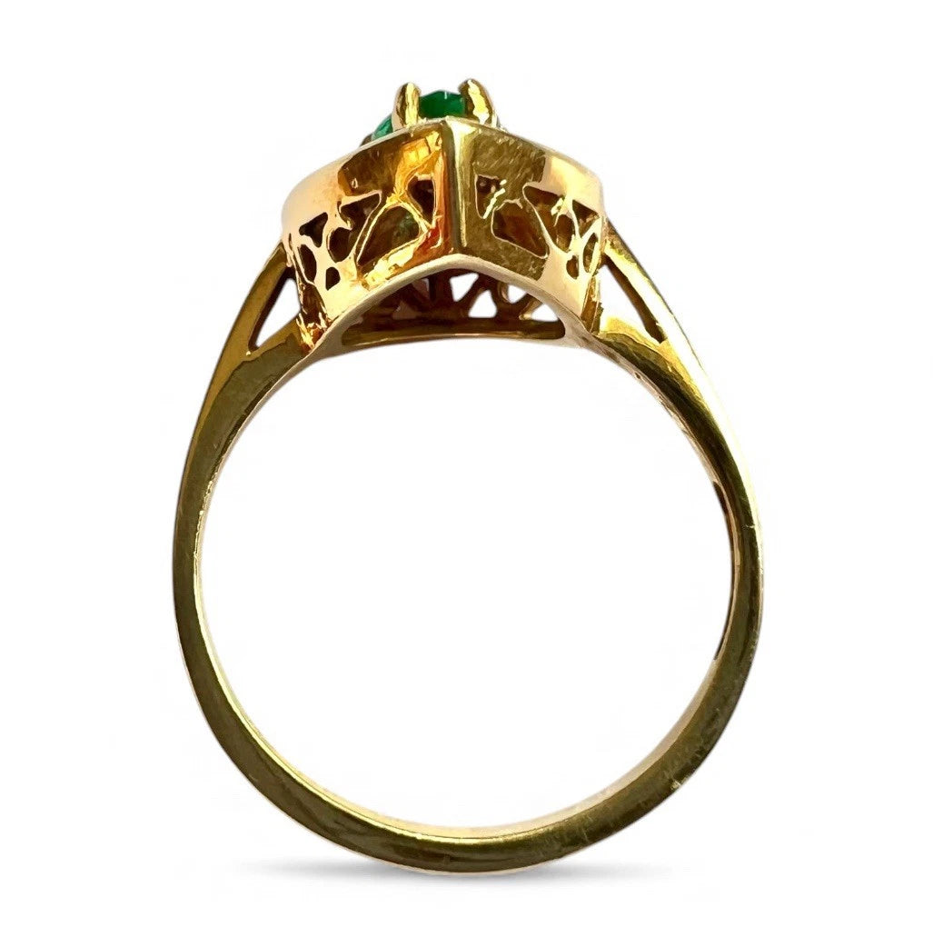 Gold ring with a green gemstone on a white background