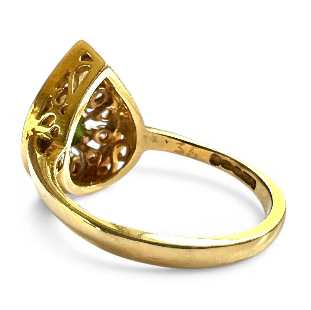 Gold ring with intricate design on a white background