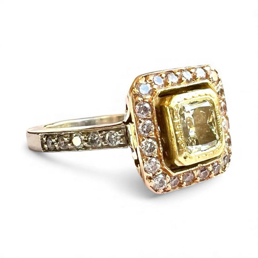 Gold ring with a large yellow diamond central gemstone and smaller fancy pink diamonds on a white background