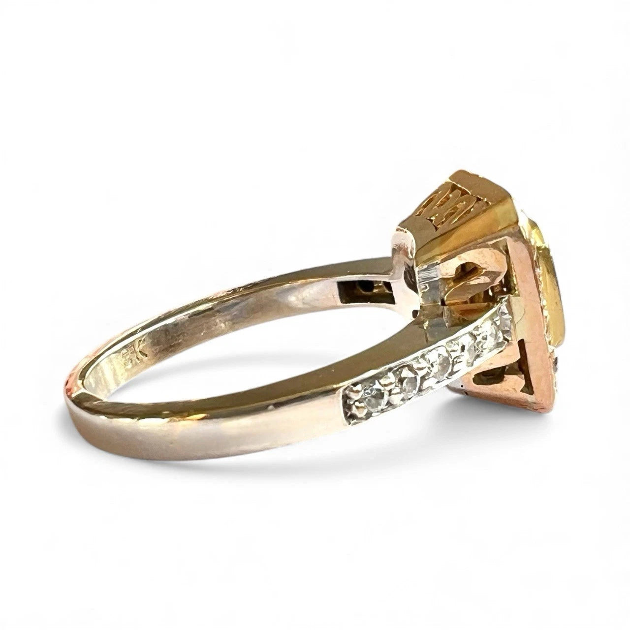 Gold ring with a large yellow diamond and smaller diamonds on a white background