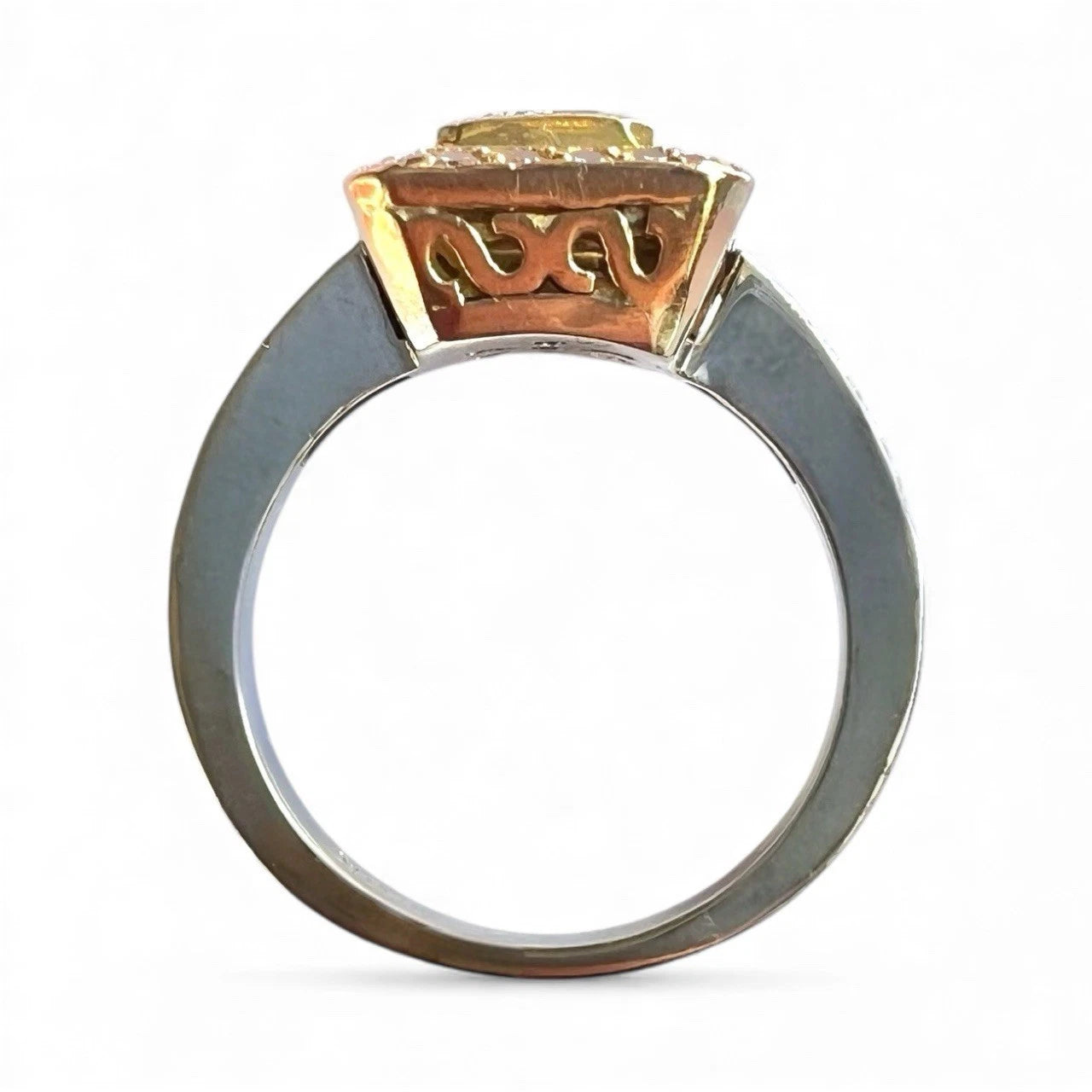 Gold ring with a prominent gemstone on a white background