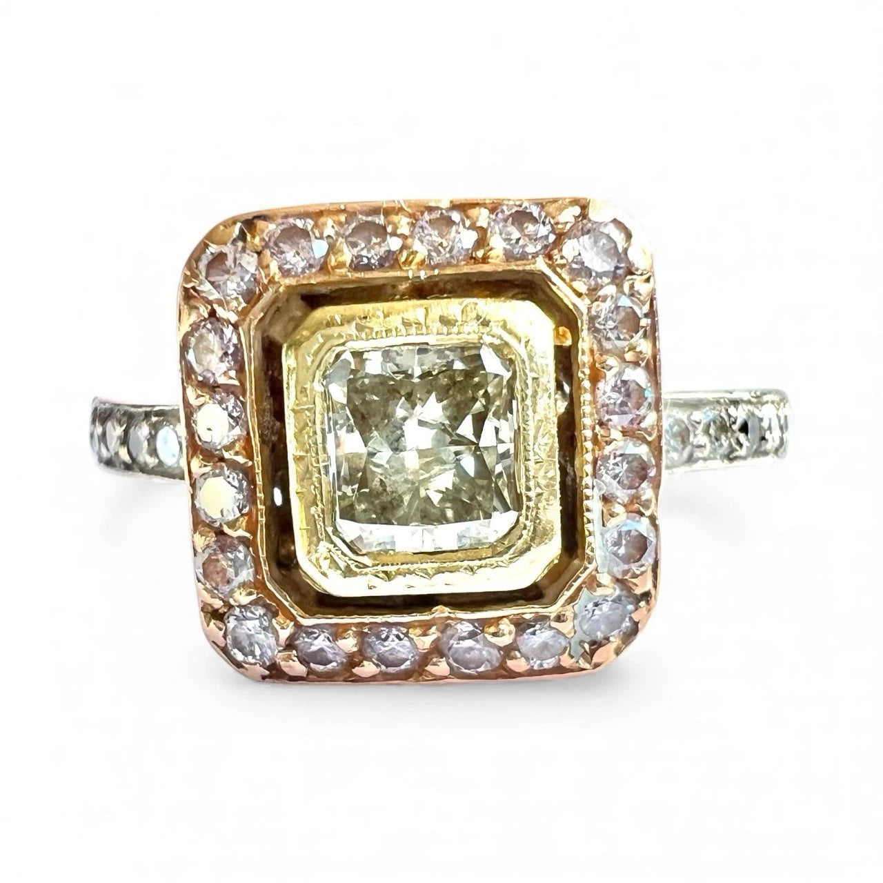 Gold ring with a large central yellow diamond and smaller fancy pink diamonds around on a white background