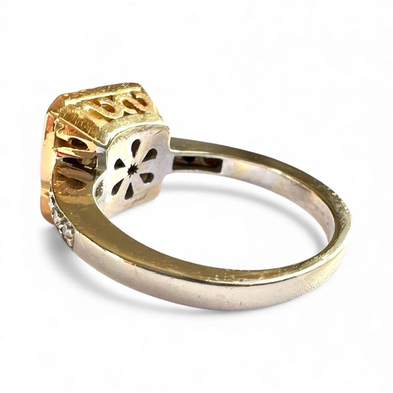 Gold ring with a unique design on a white background