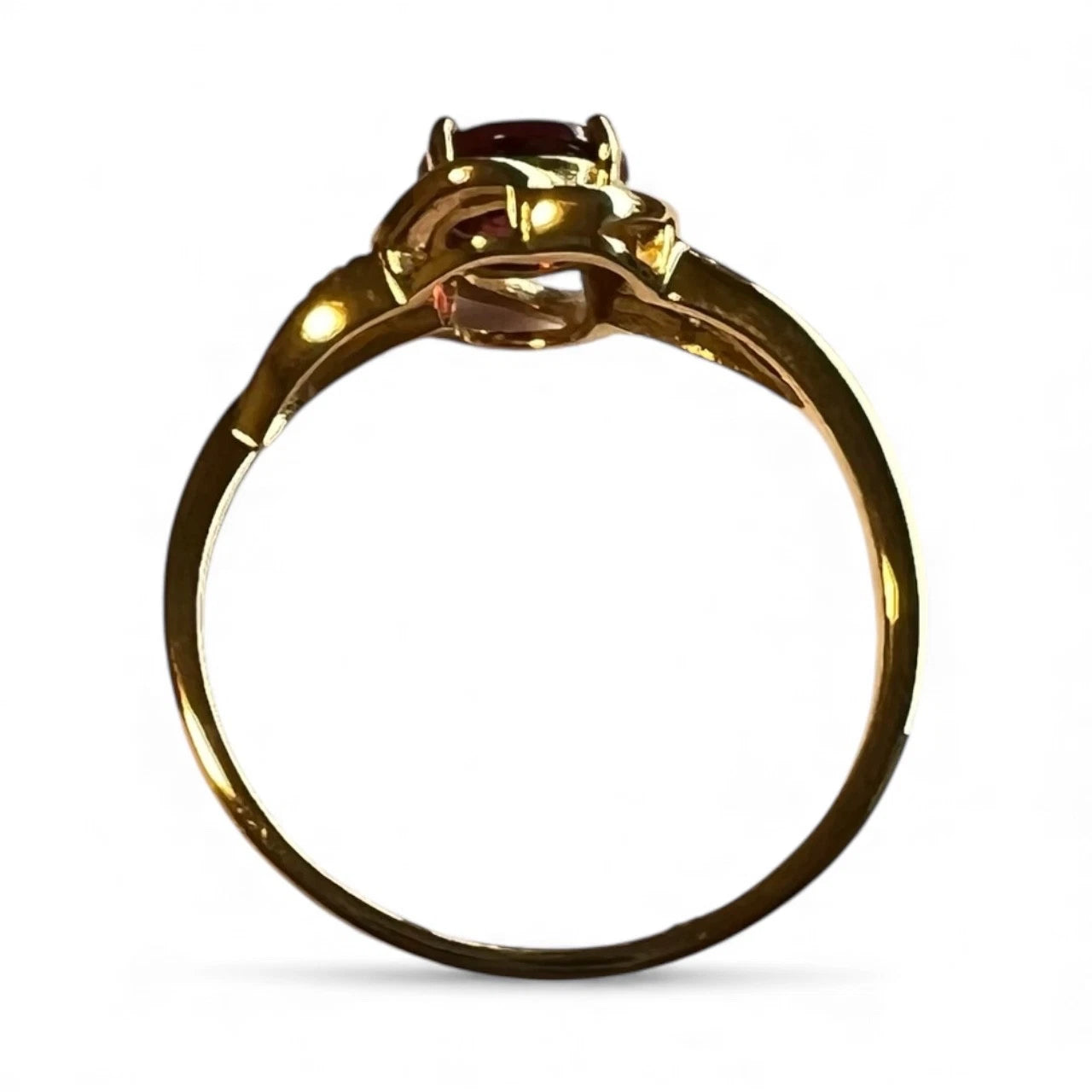 Gold ring with a central gemstone on a white background