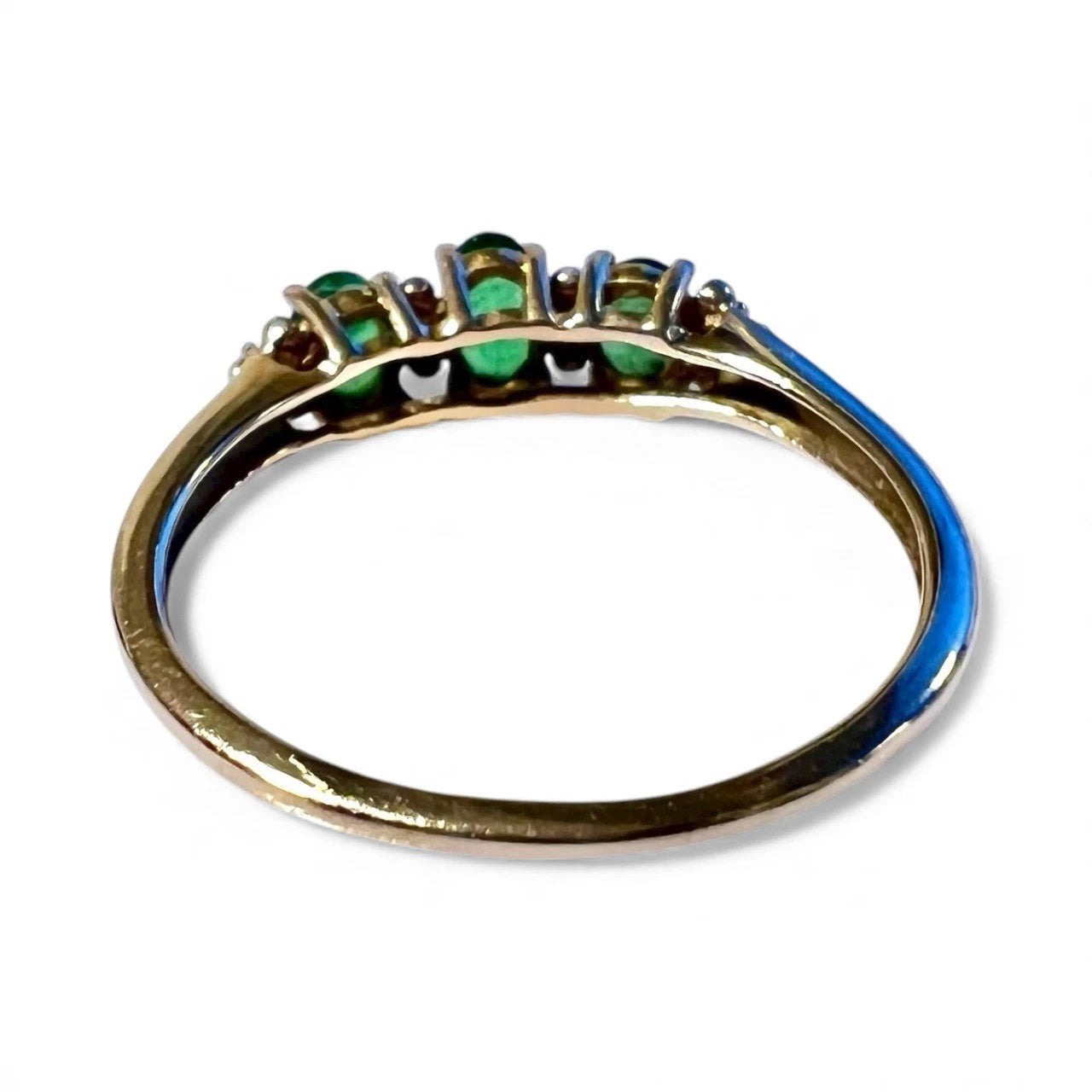 Gold ring with diopside and diamonds rear view of setting and gold band on a white background 