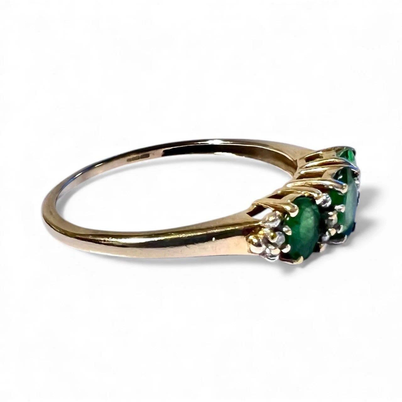 Side view 9ct gold ring with Green diopside and diamond three stone ring on a white background 