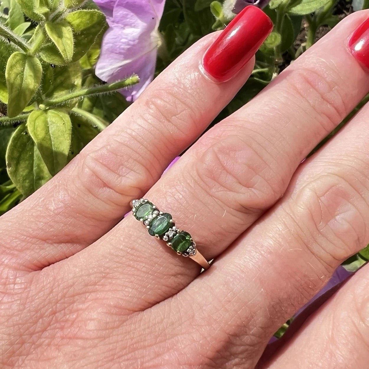 9ct Gold Green diopside and diamond ring on  ladies hand in natural light 