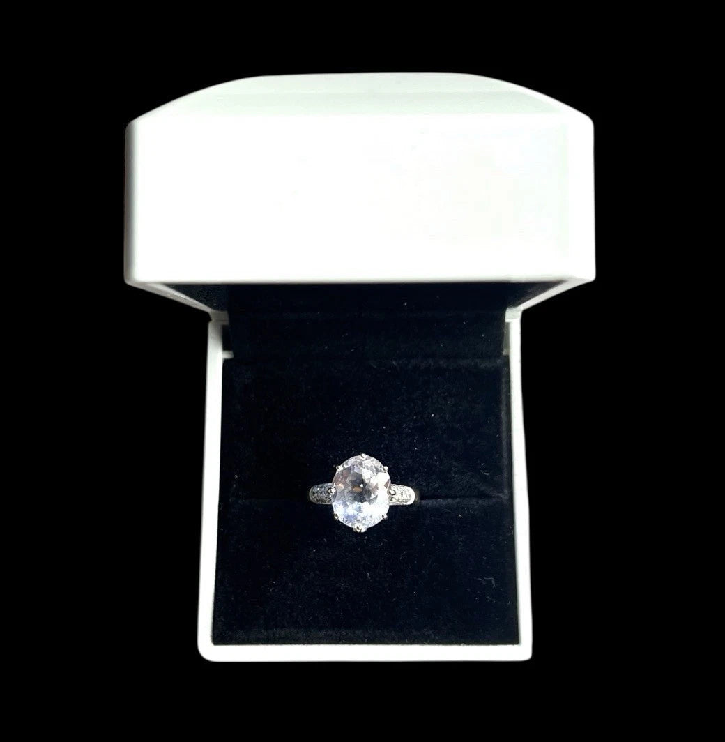 Quartz and diamond ring in a white box on a black background
