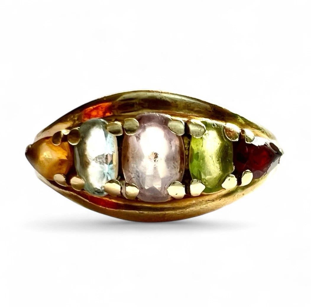 Close-up front view of Gold ring with embedded multicoloured gemstones on a white background