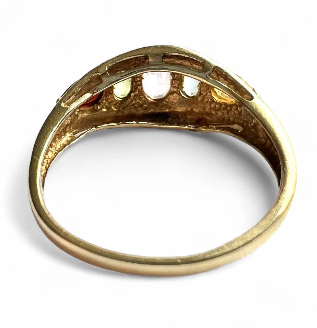 Gold ring with five multicoloured gemstones on a white background close up of rear view setting and gold band 