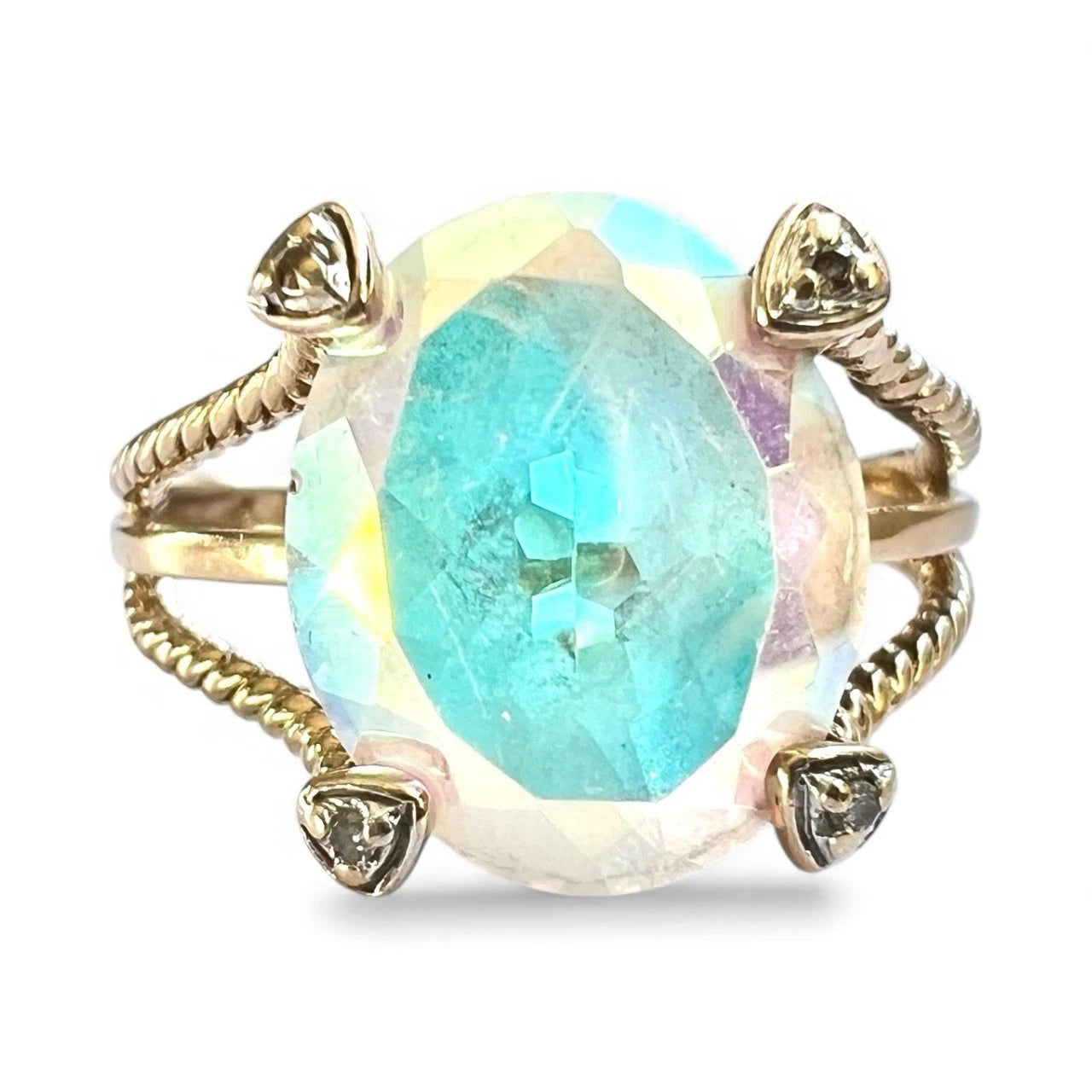 Gold ring with a large faceted mystic quartz gemstone on a white background close up front view 