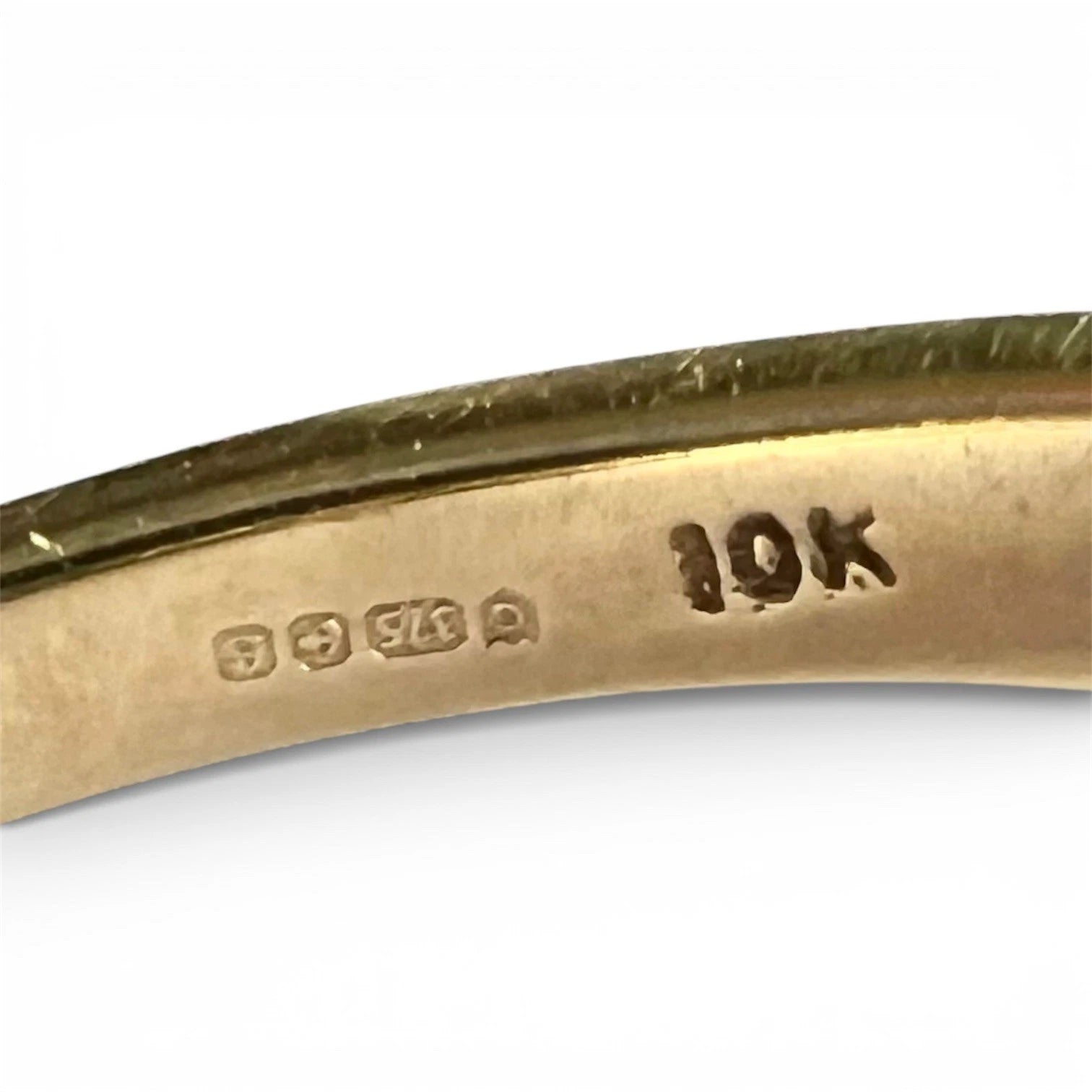 Gold ring with '10K' hallmark on a white background