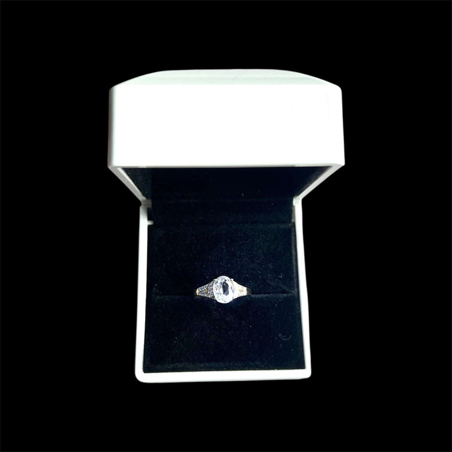 Quart and Diamond ring in a white box on a black background