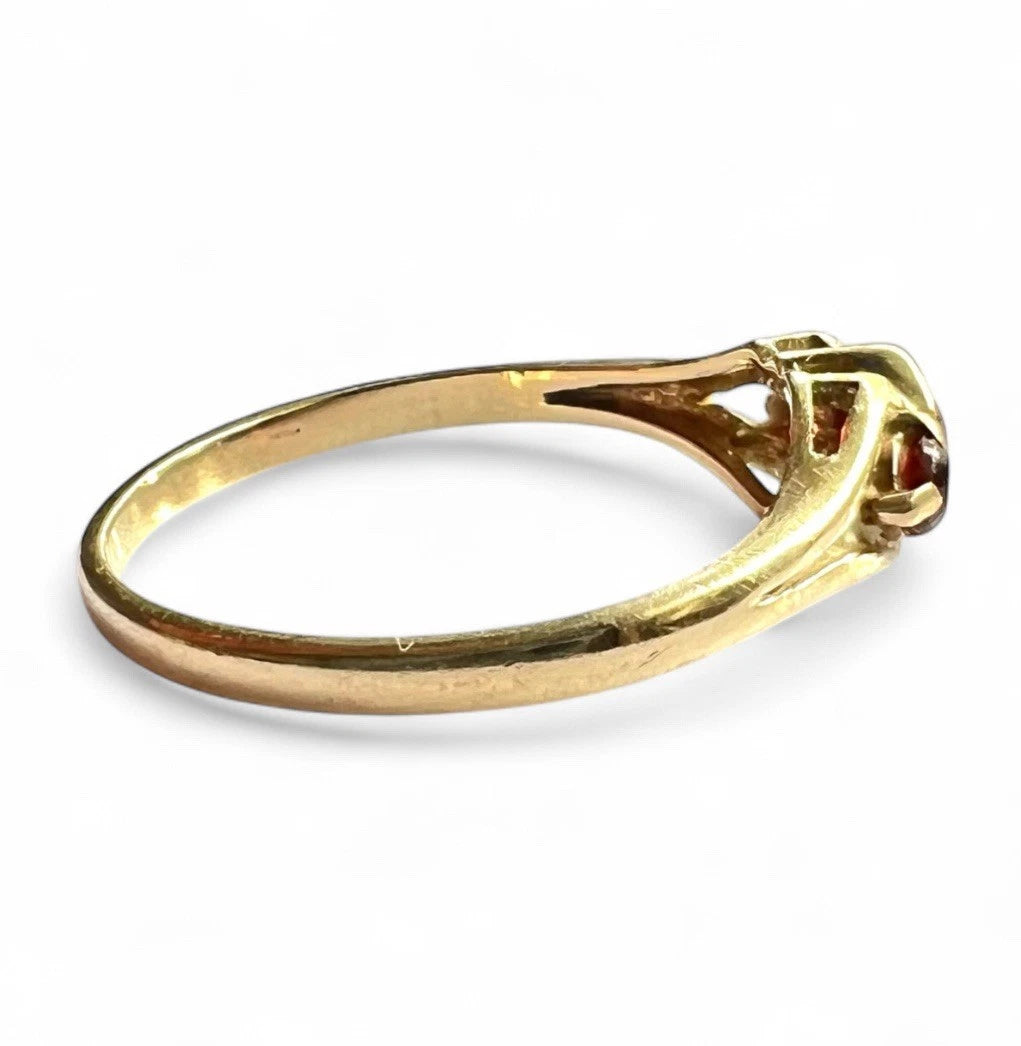 Gold ring with a diamond on a white background
