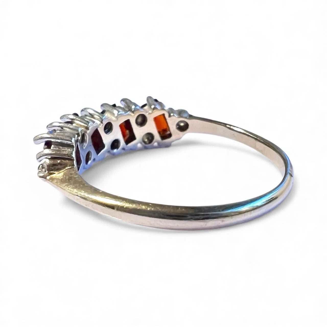 Gold ring with embedded stones on a white background