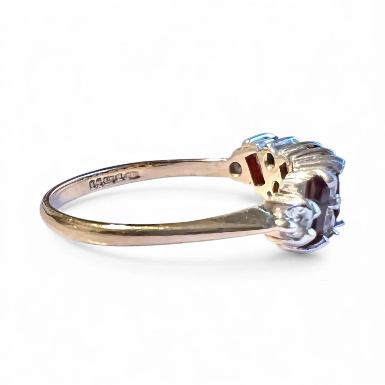 Gold ring with a cubic zirconia on a white background. Close up side view 