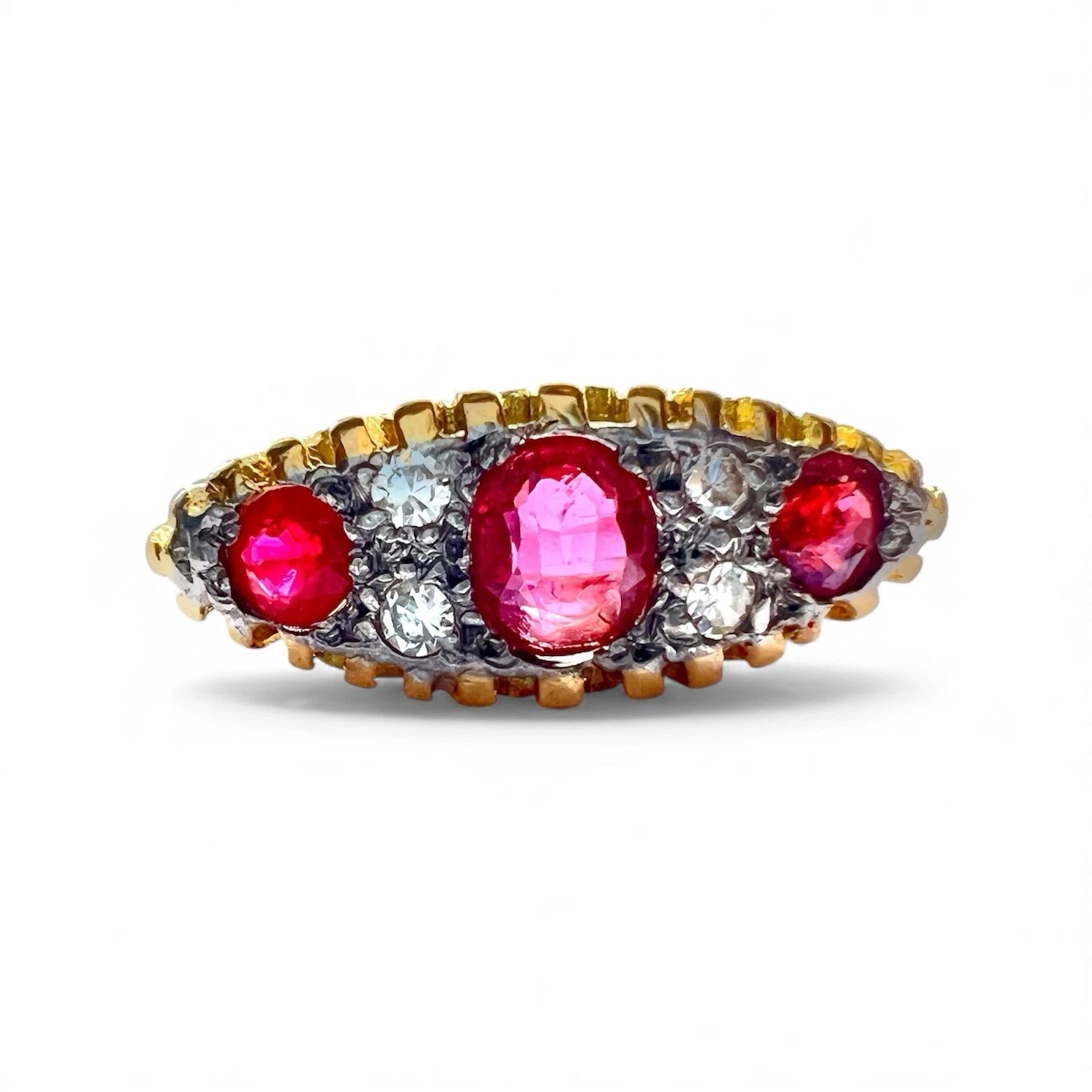 Antique Gold ring with red ruby gemstones and diamonds on a white background. Close up front view 