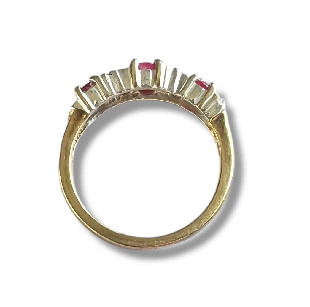 Gold ring with gemstones on a white background 