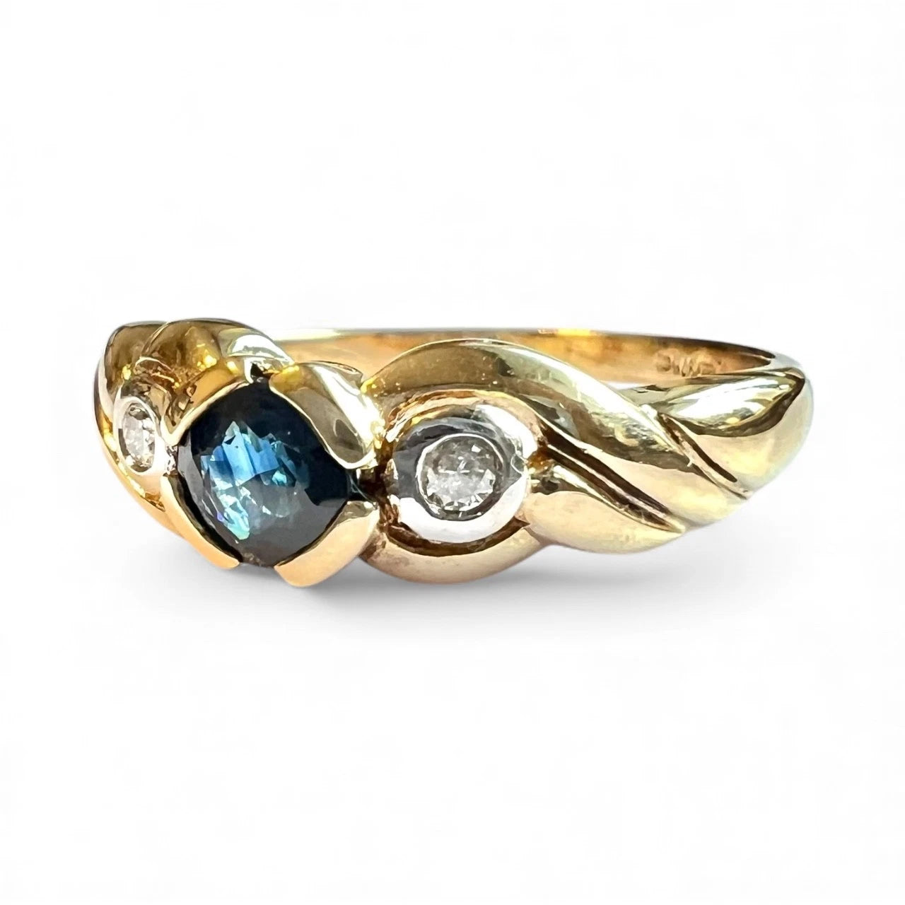 Gold ring with a blue sapphire gemstone and diamonds on a white background