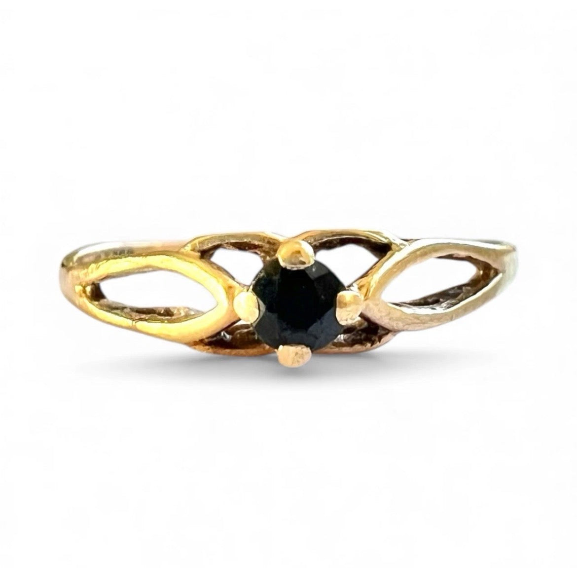 Gold ring with a sapphire gemstone on a white background