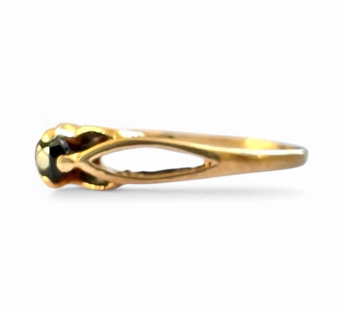 Gold ring with a sapphire stone on a white background