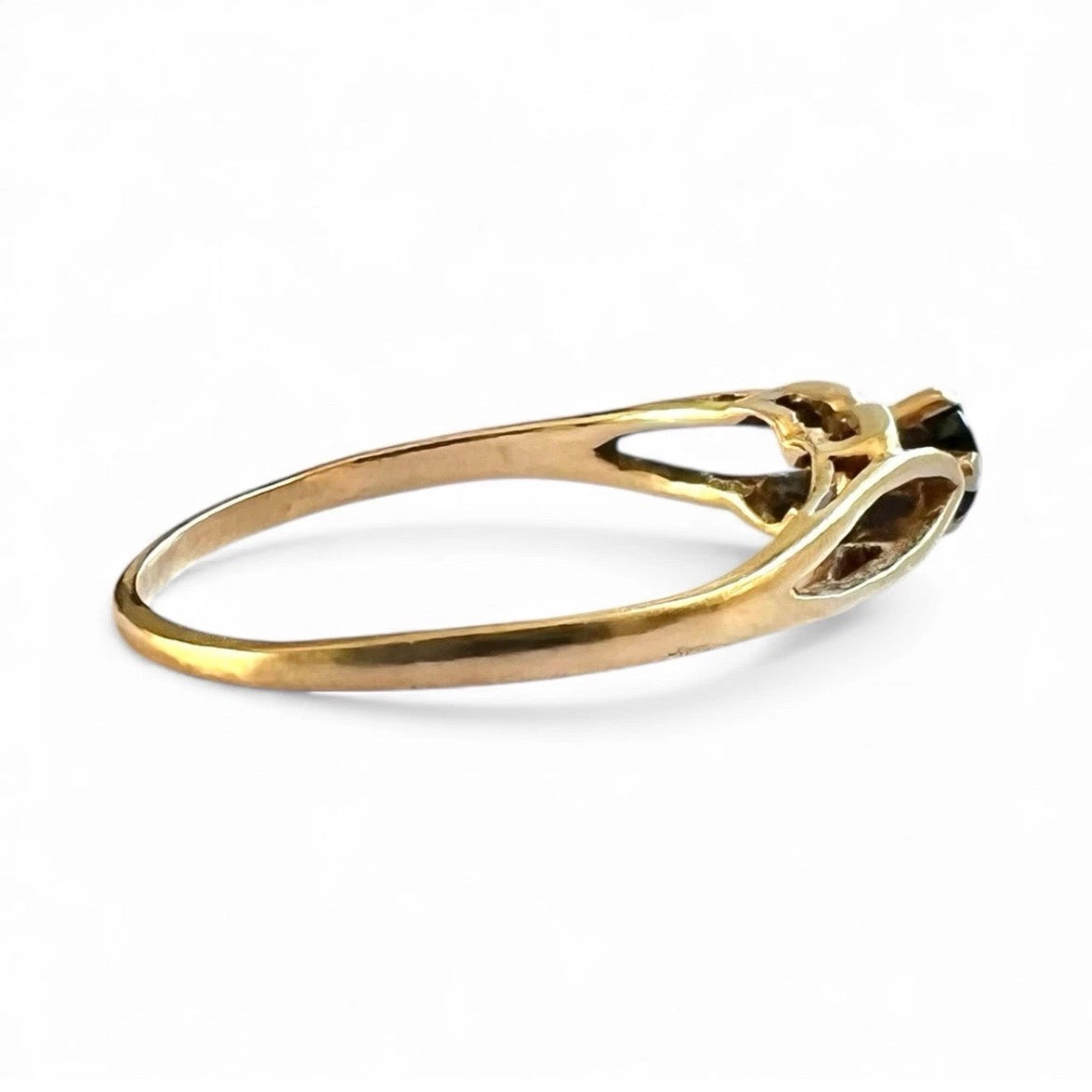 Gold ring with a gemstone on a white background