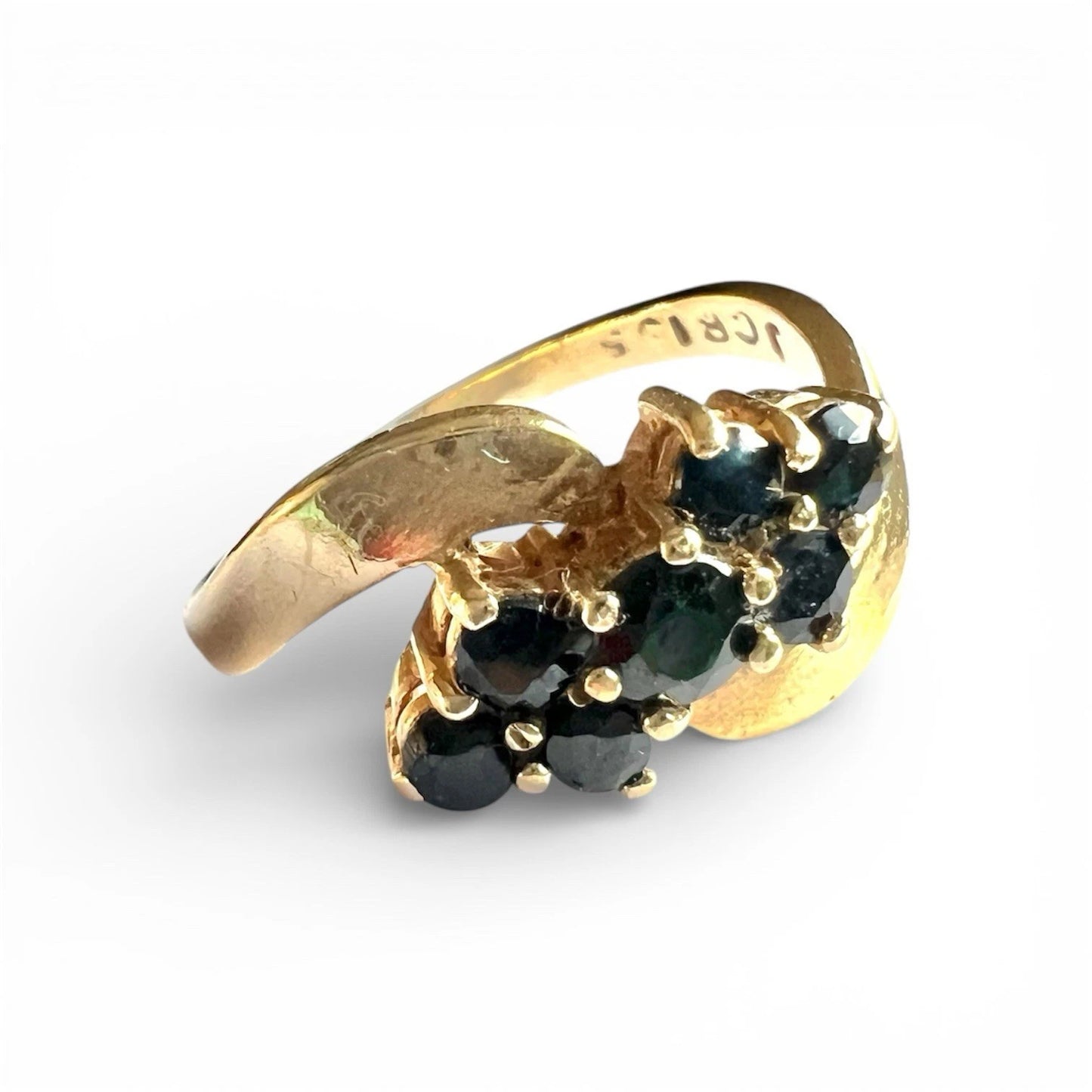 Close up gold ring with sapphire gemstones on a white background