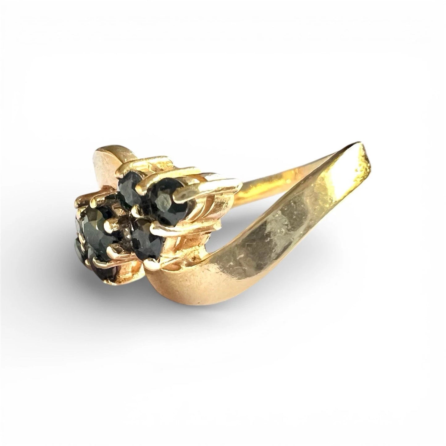 Gold ring with sapphire gemstones on a white background