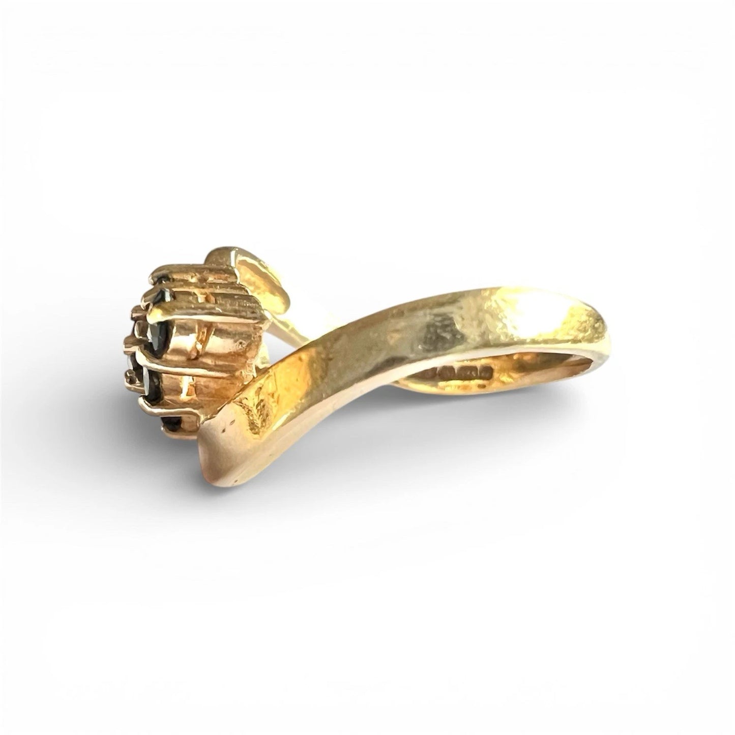 Gold ring with a unique design on a white background