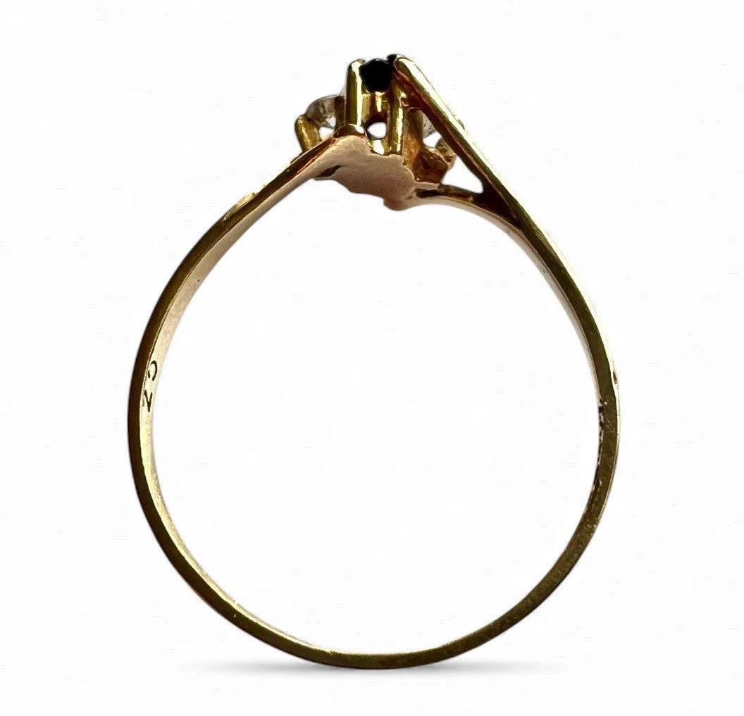 Gold ring with a sapphire gemstone on a white background