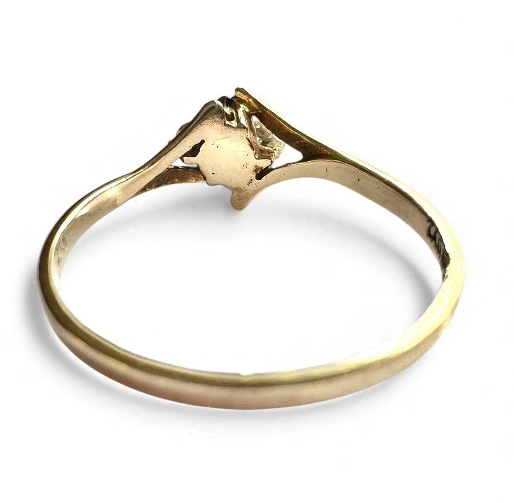 Gold ring with sapphire and CZ on a white background