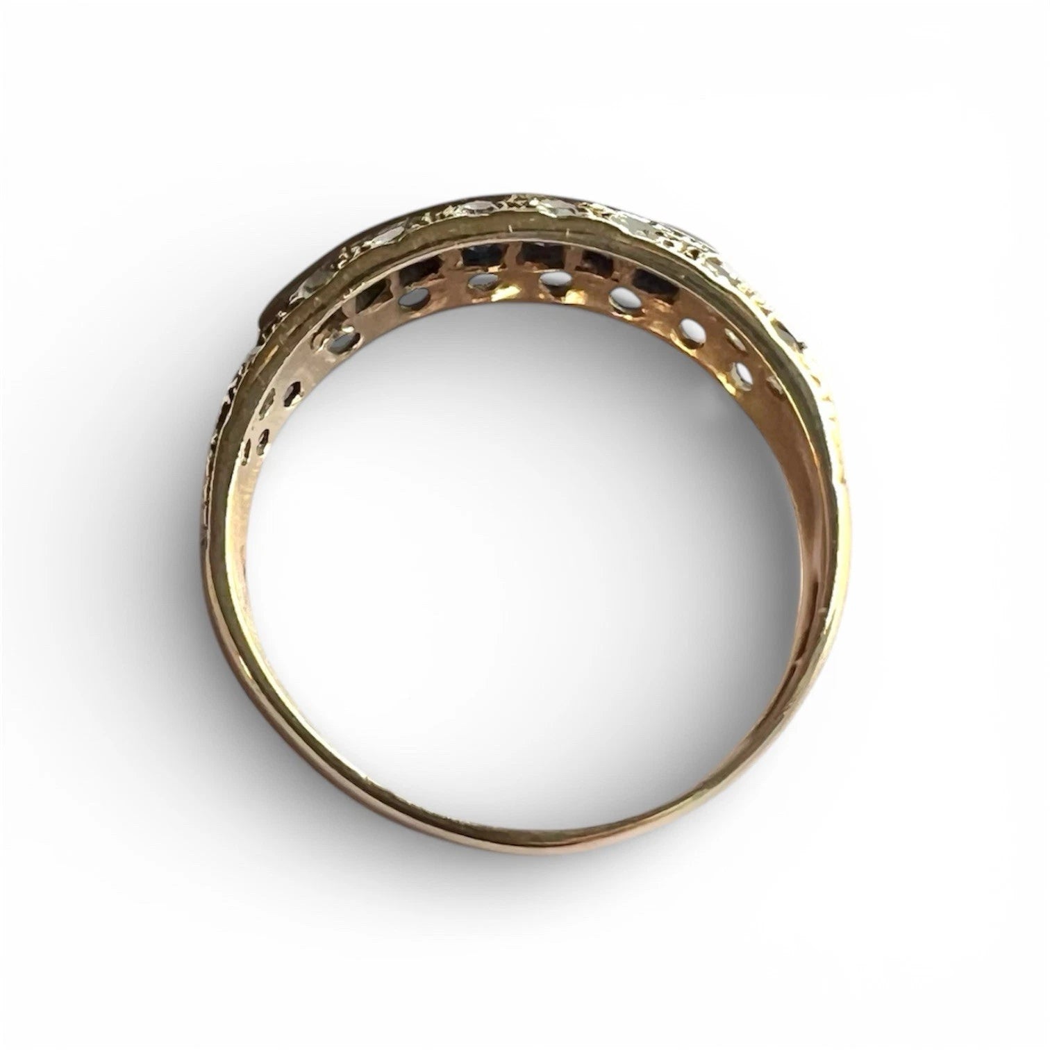 Gold ring with sapphire and cubic zirconia top down view on a white background