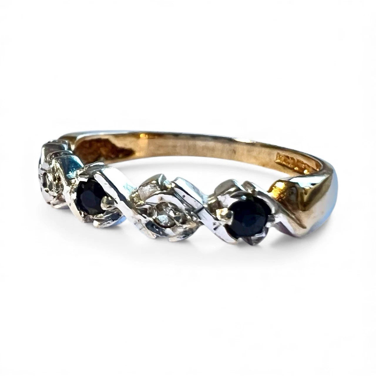 Gold ring with sapphires and diamonds on a white background