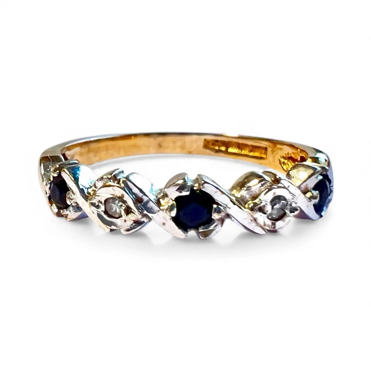 9ct Gold ring with sapphire and diamond gemstones on a white background