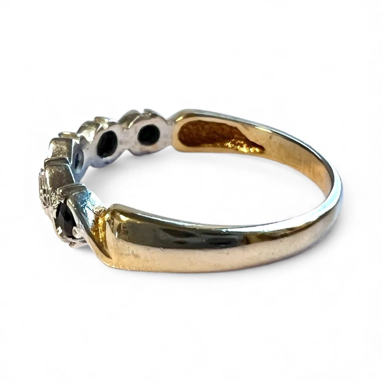 Gold ring with gemstones on a white background. Close up Side view 